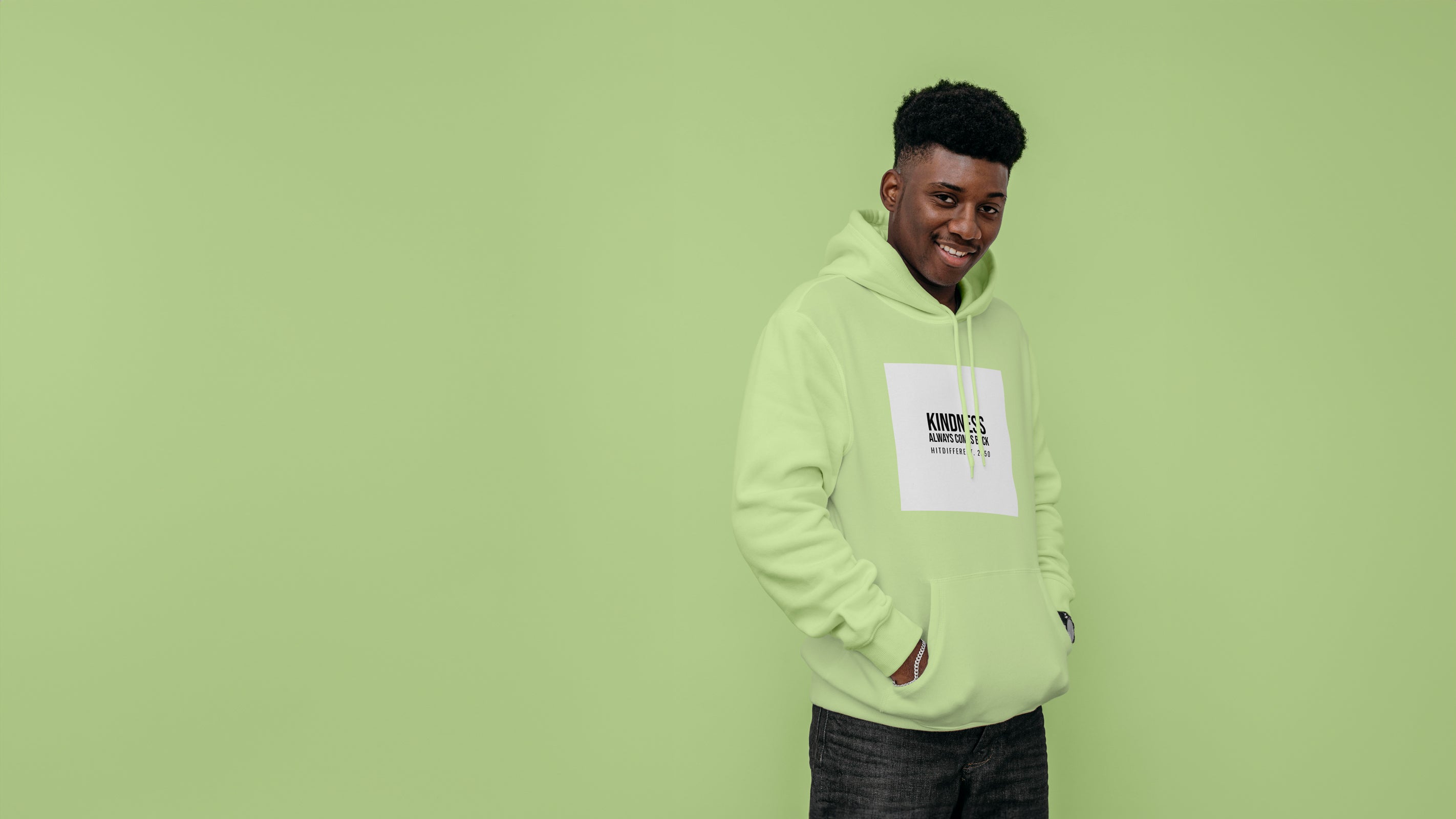 male model wearing  HITDIFFERENT sustainable eco friendly hoodie in green stading in front of green background